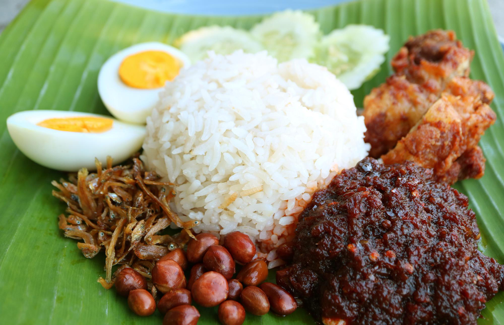 Plate of Malaysian nasi lemak with spicy sambal made from prawn paste
